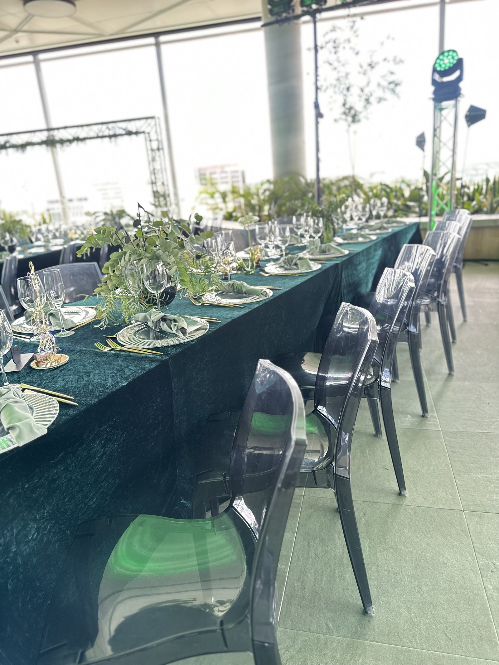 Premium boardroom-style corporate dinner setup with floral centrepieces