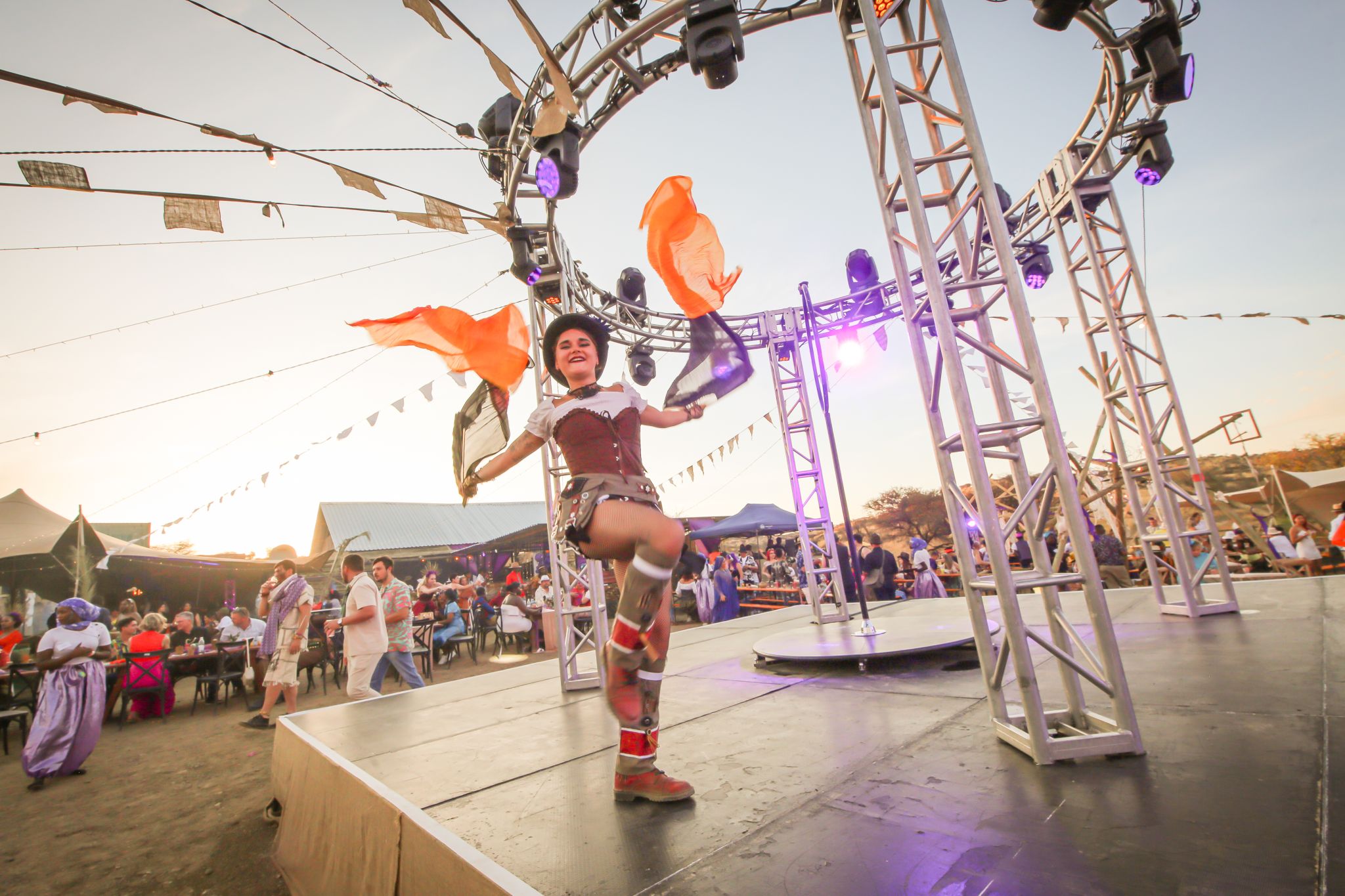 Live band performance at a corporate festival, golden hour outdoor stage with festival crowd in background