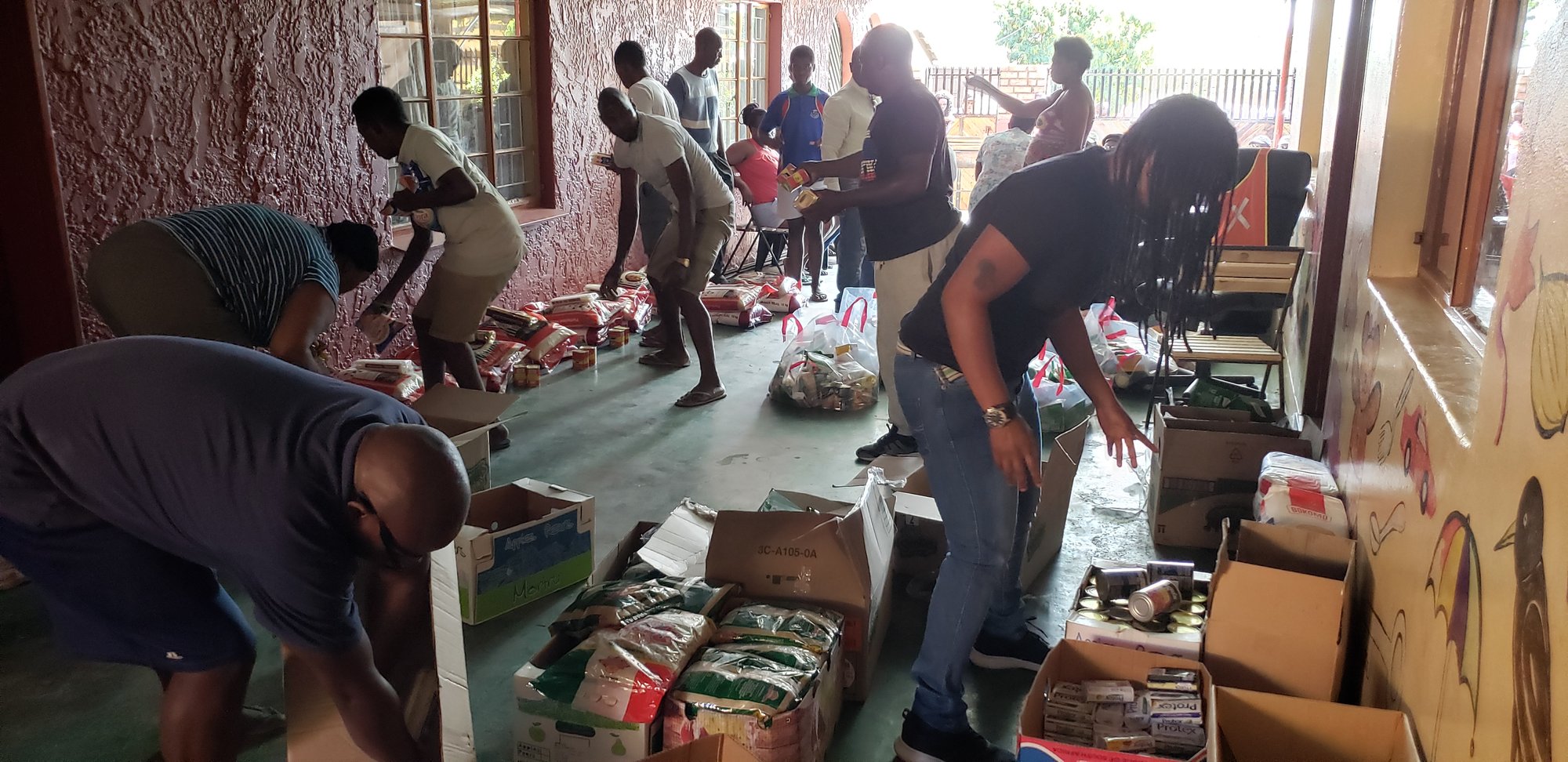 Volunteers packing food parcels in a community space